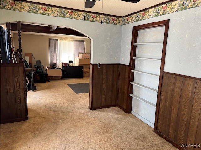 52 S New York St, Lockport-City, NY 14094 - dining area with carpet, wainscoting, ceiling fan, wooden walls, and arched walkways