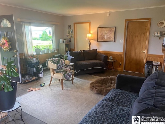 6607 Lake Dr, Portland, NY 14769 - living area featuring wood finished floors, crown molding, and a wainscoted wall