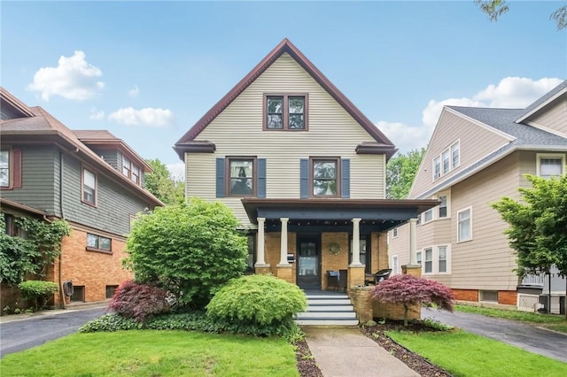 865 Harvard St, Rochester, NY 14610 - view of front of house with a porch and a front lawn