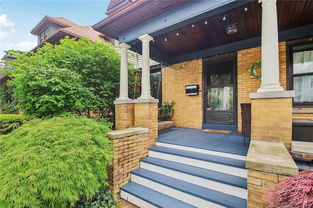 865 Harvard St, Rochester, NY 14610 - property entrance featuring a porch and brick siding