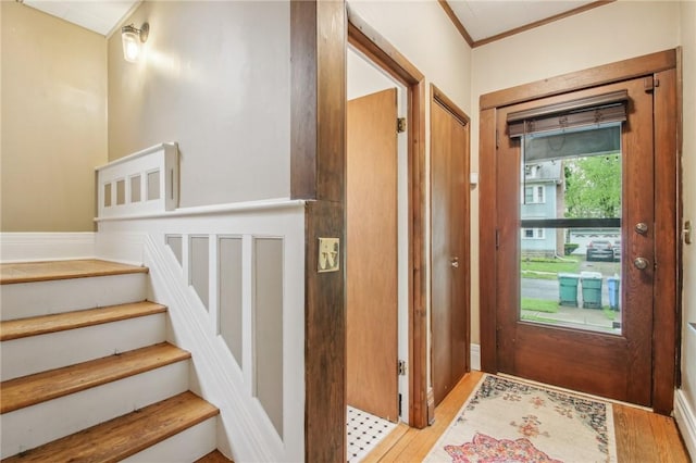 865 Harvard St, Rochester, NY 14610 - entrance foyer with stairway, crown molding, and light wood-style floors