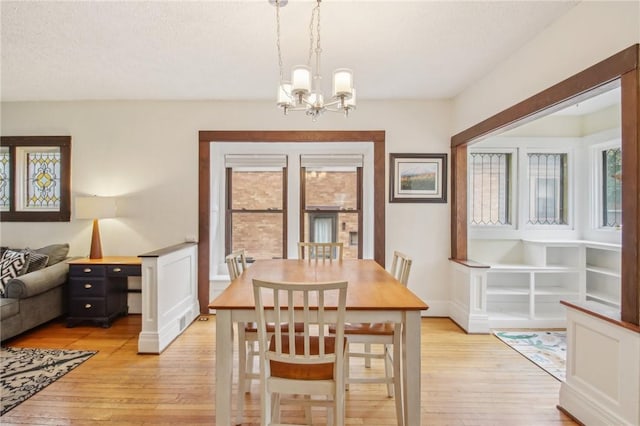 865 Harvard St, Rochester, NY 14610 - dining area with light wood-style floors, a chandelier, and healthy amount of natural light