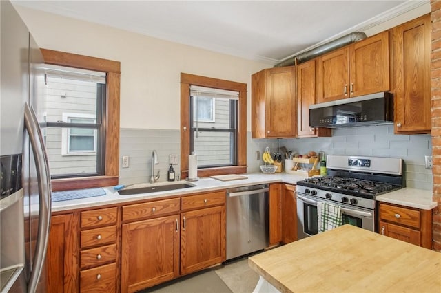865 Harvard St, Rochester, NY 14610 - kitchen featuring stainless steel appliances, a sink, light countertops, decorative backsplash, and ornamental molding