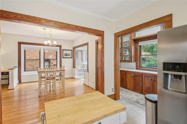 865 Harvard St, Rochester, NY 14610 - dining space with a chandelier, ornamental molding, and light wood-type flooring