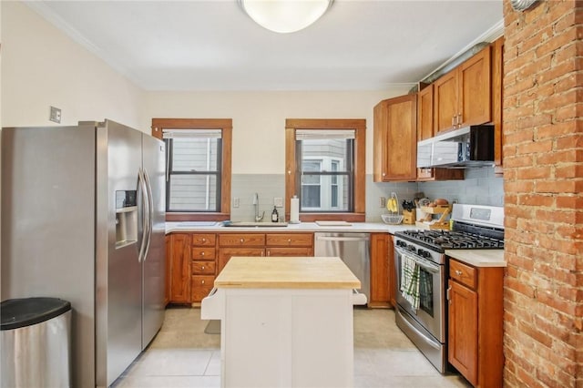 865 Harvard St, Rochester, NY 14610 - kitchen with appliances with stainless steel finishes, a sink, butcher block countertops, tasteful backsplash, and healthy amount of natural light