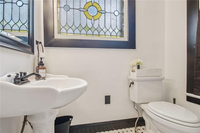 865 Harvard St, Rochester, NY 14610 - half bath with toilet, a sink, and baseboards