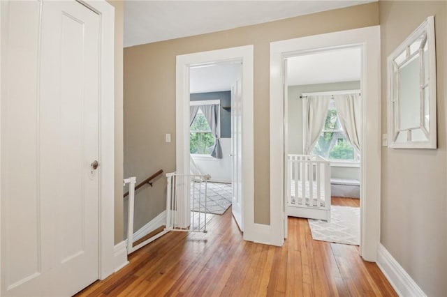 865 Harvard St, Rochester, NY 14610 - hall with an upstairs landing, light wood-type flooring, and baseboards