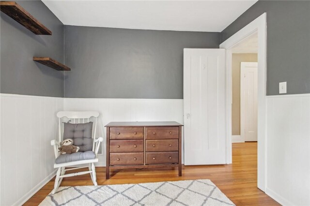 865 Harvard St, Rochester, NY 14610 - living area featuring wood finished floors and a wainscoted wall