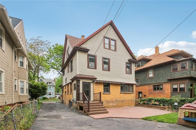865 Harvard St, Rochester, NY 14610 - view of front facade featuring brick siding and a gate