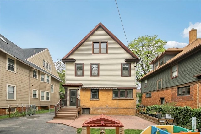 865 Harvard St, Rochester, NY 14610 - rear view of house with brick siding and a patio area
