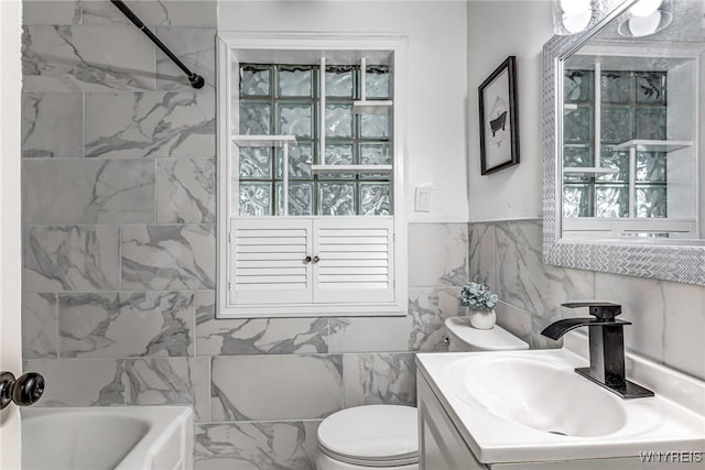 296 Burke Dr, Cheektowaga, NY 14215 - bathroom featuring vanity, toilet, tile walls, and tub / shower combination