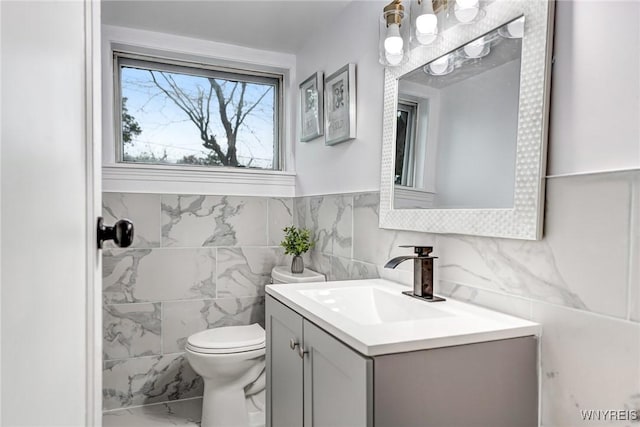 296 Burke Dr, Cheektowaga, NY 14215 - half bathroom featuring marble look tiles, vanity, toilet, and tile walls