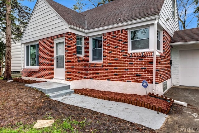 296 Burke Dr, Cheektowaga, NY 14215 - view of front of property with brick siding, a shingled roof, and an attached garage