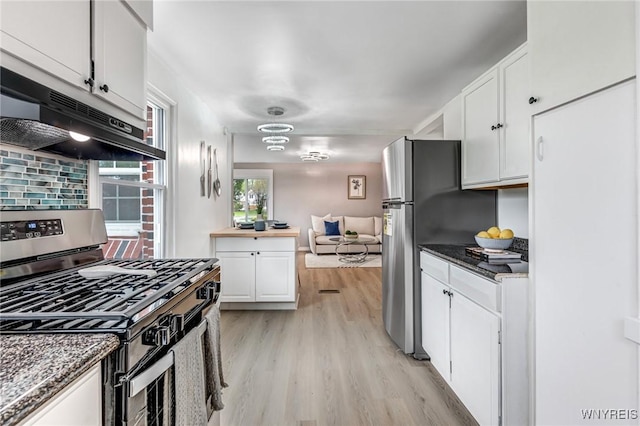 296 Burke Dr, Cheektowaga, NY 14215 - kitchen with stainless steel appliances, exhaust hood, white cabinetry, light wood finished floors, and dark stone counters