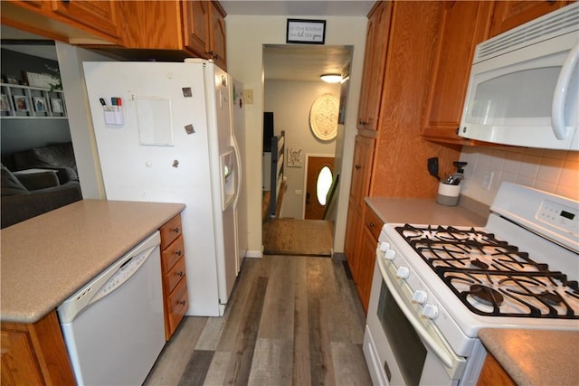 2314 Vandy Dr, Macedon, NY 14522 - kitchen with white appliances, brown cabinets, wood finished floors, backsplash, and light countertops