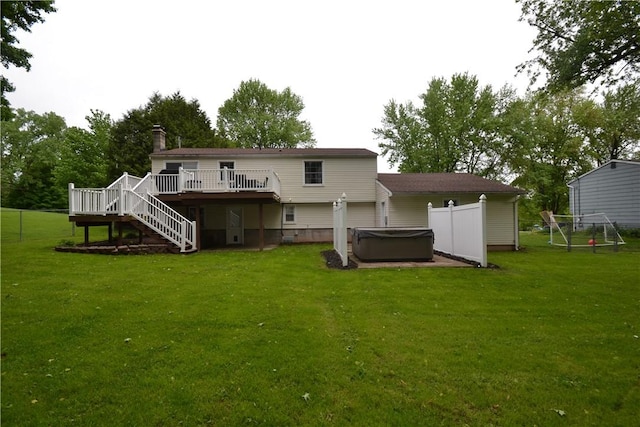 2314 Vandy Dr, Macedon, NY 14522 - rear view of house featuring a hot tub, a wooden deck, stairs, a chimney, and a lawn