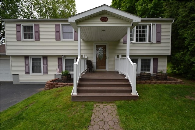 2314 Vandy Dr, Macedon, NY 14522 - split foyer home featuring a front yard, driveway, and a garage
