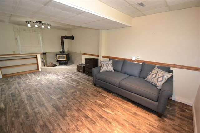 2314 Vandy Dr, Macedon, NY 14522 - living room with a wood stove, wood finished floors, a paneled ceiling, baseboards, and track lighting