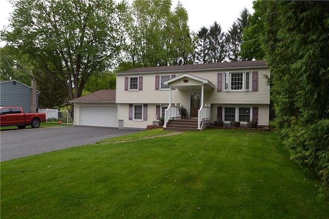 2314 Vandy Dr, Macedon, NY 14522 - split foyer home featuring asphalt driveway, a front yard, and a garage