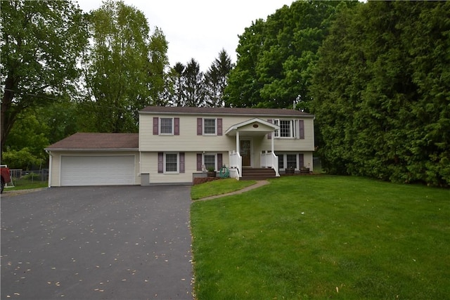 2314 Vandy Dr, Macedon, NY 14522 - split foyer home with a garage, asphalt driveway, a front yard, and view of scattered trees