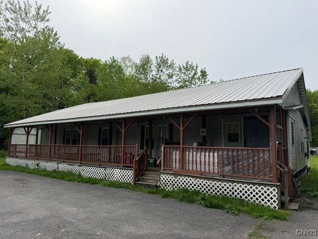 576 County Route 85, Granby, NY 13069 - view of front facade featuring covered porch and metal roof