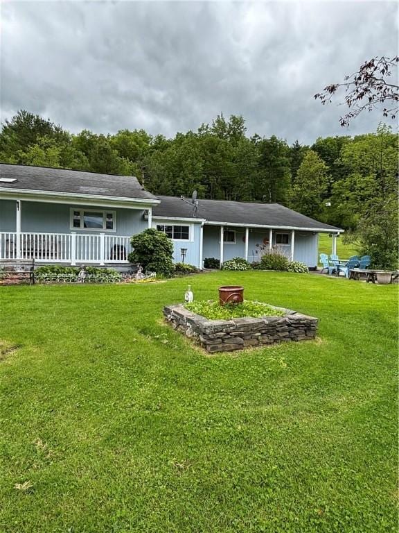 115 Depew Rd, Tioga, NY 13734 - back of property with a yard, covered porch, and a forest view