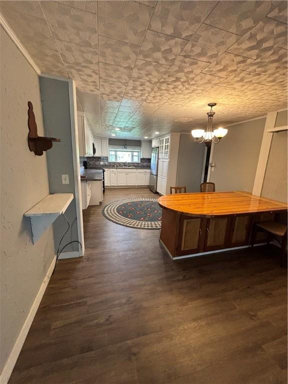 115 Depew Rd, Tioga, NY 13734 - kitchen with freestanding refrigerator, dark wood-type flooring, white cabinets, baseboards, and a kitchen island