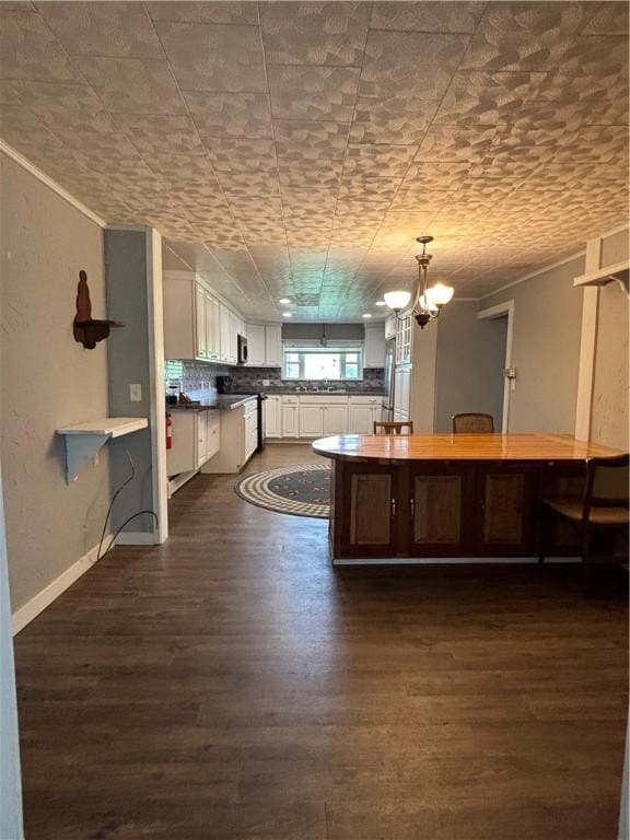 115 Depew Rd, Tioga, NY 13734 - kitchen with dark wood-style flooring, white cabinets, hanging light fixtures, a chandelier, and a sink