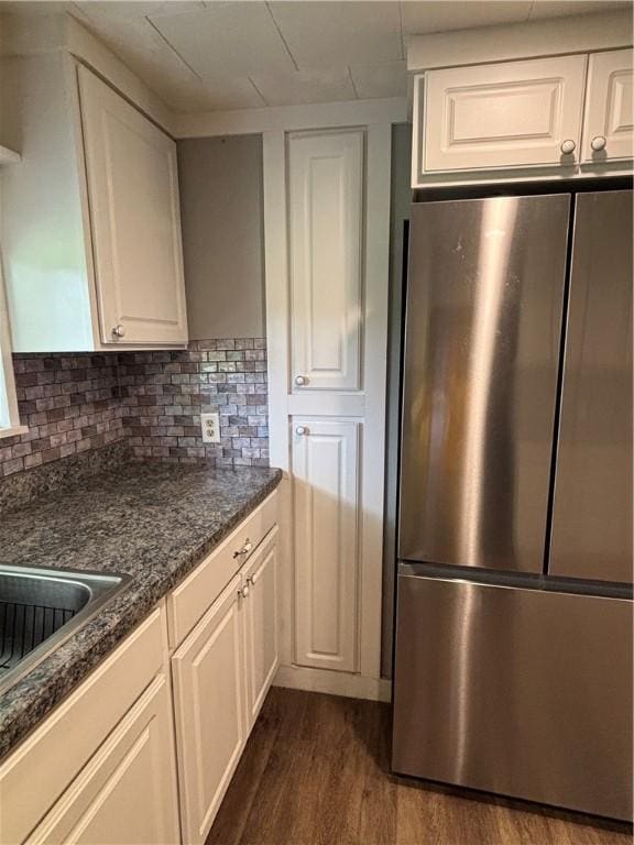 115 Depew Rd, Tioga, NY 13734 - kitchen with freestanding refrigerator, dark wood-style flooring, white cabinetry, and backsplash