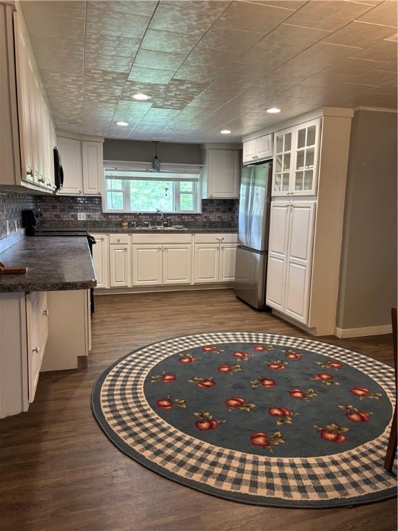 115 Depew Rd, Tioga, NY 13734 - kitchen featuring freestanding refrigerator, dark countertops, decorative backsplash, a sink, and dark wood-type flooring