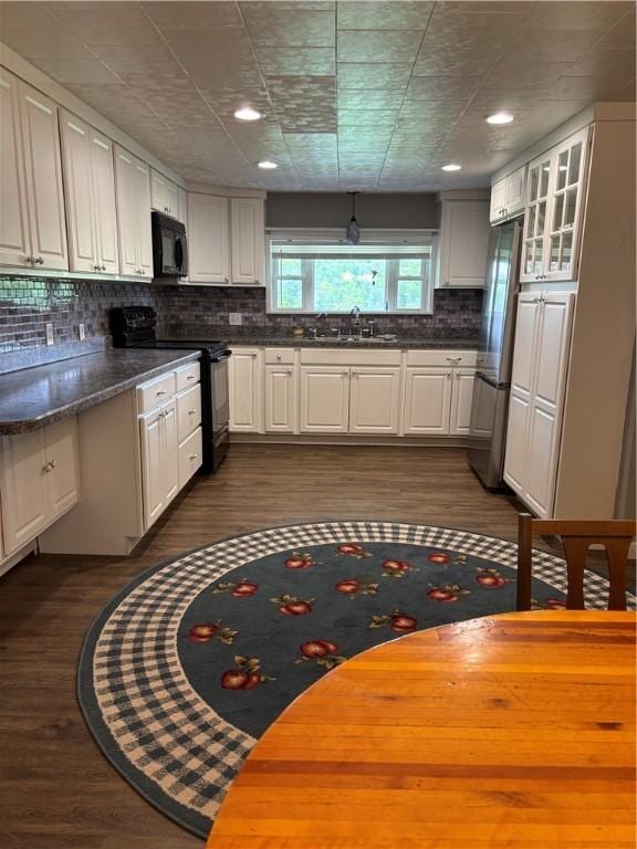 115 Depew Rd, Tioga, NY 13734 - kitchen featuring black appliances, dark countertops, backsplash, a sink, and white cabinets