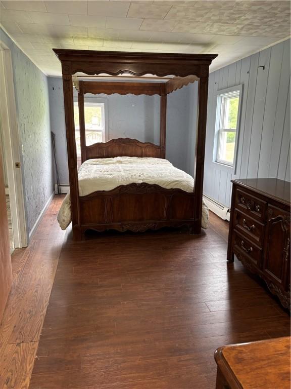 115 Depew Rd, Tioga, NY 13734 - bedroom featuring a baseboard heating unit and wood finished floors