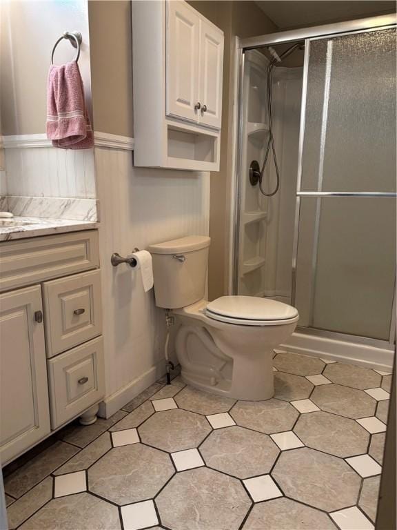 115 Depew Rd, Tioga, NY 13734 - full bath with a stall shower, toilet, vanity, tile patterned floors, and a wainscoted wall