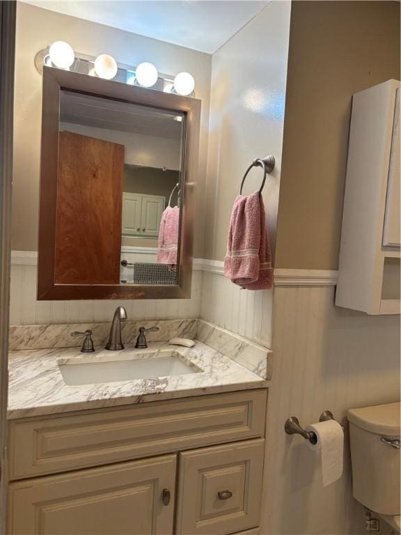 115 Depew Rd, Tioga, NY 13734 - bathroom featuring vanity, a wainscoted wall, and toilet