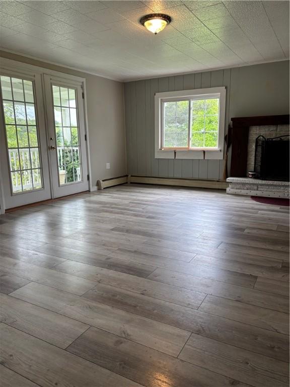115 Depew Rd, Tioga, NY 13734 - unfurnished living room featuring french doors, hardwood / wood-style floors, and a fireplace