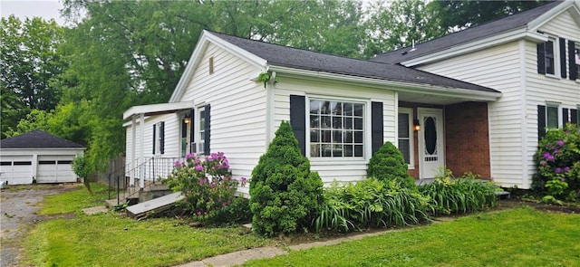 12034 Washington St, Wolcott, NY 14590 - view of property exterior featuring an outbuilding, a garage, and a yard