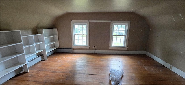 12034 Washington St, Wolcott, NY 14590 - additional living space with vaulted ceiling, hardwood / wood-style flooring, a baseboard heating unit, and baseboards