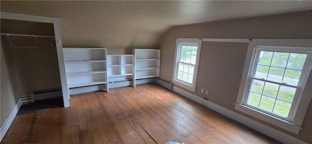 12034 Washington St, Wolcott, NY 14590 - unfurnished bedroom featuring lofted ceiling, hardwood / wood-style flooring, multiple windows, and baseboards