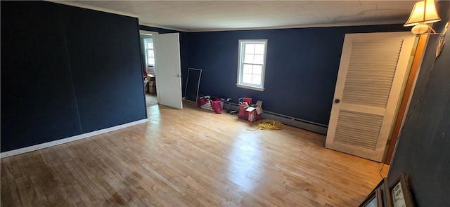 12034 Washington St, Wolcott, NY 14590 - unfurnished room featuring a baseboard radiator, crown molding, wood finished floors, and baseboards