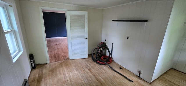 12034 Washington St, Wolcott, NY 14590 - spare room featuring light wood-style floors, crown molding, and wood walls