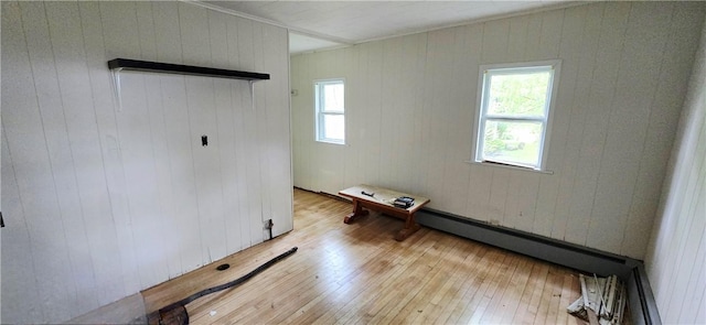12034 Washington St, Wolcott, NY 14590 - spare room featuring healthy amount of natural light, light wood finished floors, wood walls, and crown molding