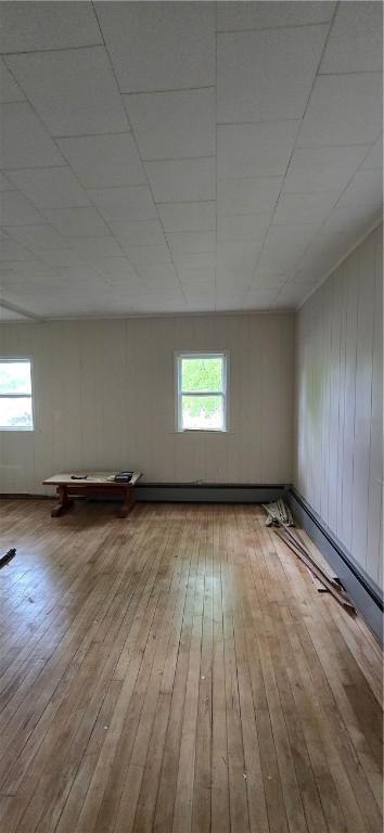 12034 Washington St, Wolcott, NY 14590 - empty room featuring hardwood / wood-style floors and healthy amount of natural light