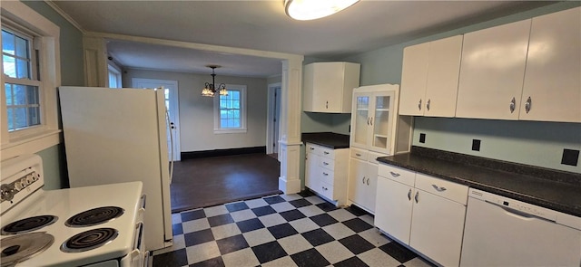 12034 Washington St, Wolcott, NY 14590 - kitchen with white appliances, dark flooring, a chandelier, white cabinets, and dark countertops
