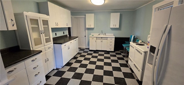 12034 Washington St, Wolcott, NY 14590 - kitchen with refrigerator with ice dispenser, dark floors, white electric range, white cabinetry, and ornamental molding