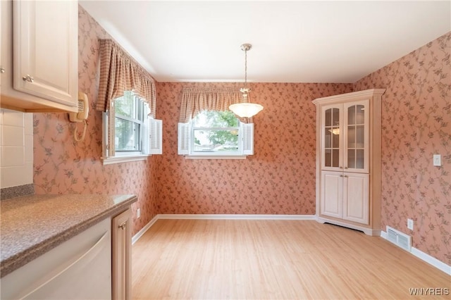 80 Hilton Blvd, Amherst, NY 14226 - unfurnished dining area featuring light wood-type flooring and baseboards
