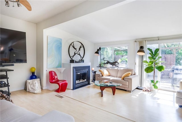 2804 Westinghouse Rd, Horseheads, NY 14845 - living area with a glass covered fireplace, wood finished floors, and a ceiling fan