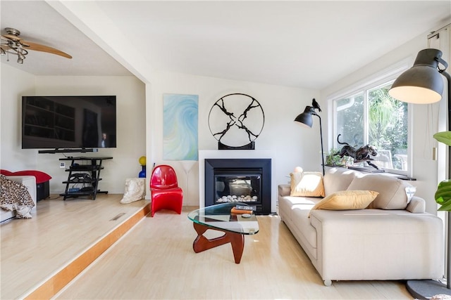 2804 Westinghouse Rd, Horseheads, NY 14845 - living room with wood finished floors, a glass covered fireplace, and ceiling fan