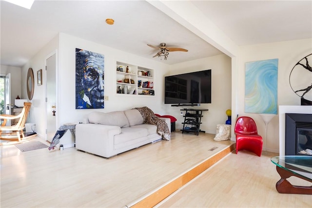 2804 Westinghouse Rd, Horseheads, NY 14845 - living area featuring wood finished floors, built in shelves, and ceiling fan