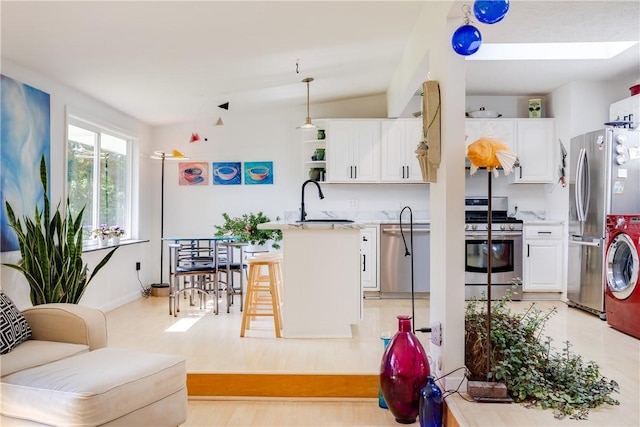 2804 Westinghouse Rd, Horseheads, NY 14845 - kitchen featuring appliances with stainless steel finishes, white cabinetry, light countertops, stacked washer and clothes dryer, and open shelves