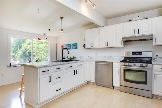 2804 Westinghouse Rd, Horseheads, NY 14845 - kitchen with appliances with stainless steel finishes, under cabinet range hood, a peninsula, white cabinets, and light wood finished floors